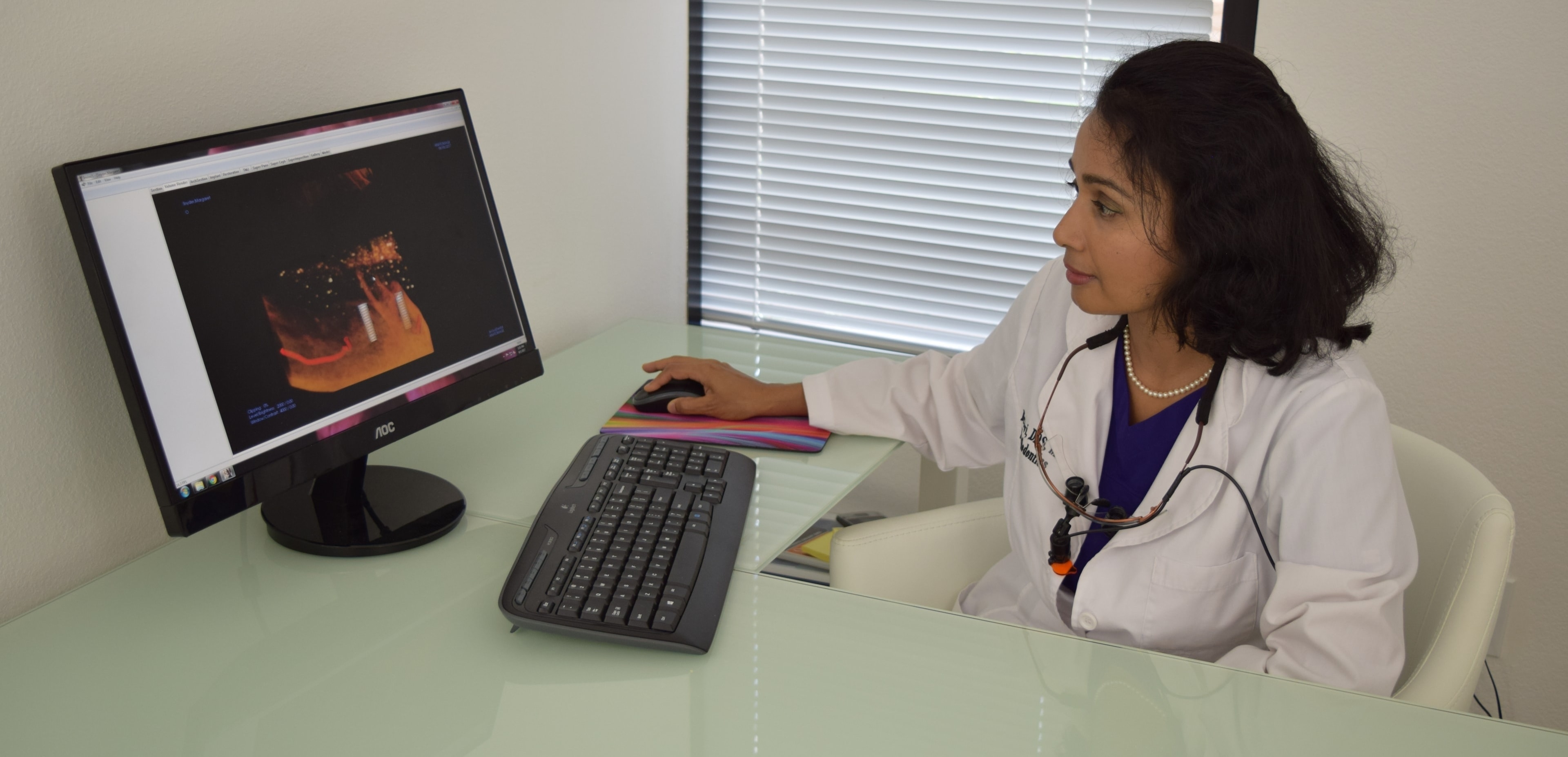 Dr. Devi reviewing dental implant imaging at Surprise Family Dentistry